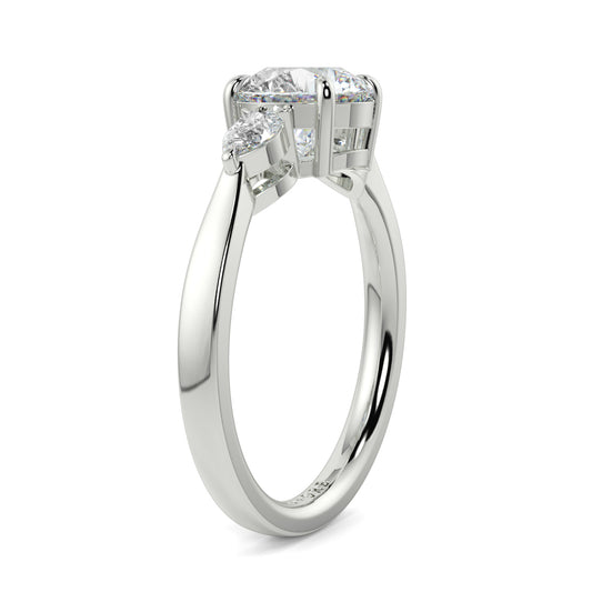 Silver ring with a diamond on a white background yb jewellers 3 stone trilogy engagement ring round and pear shape best selling design trending diamond ring