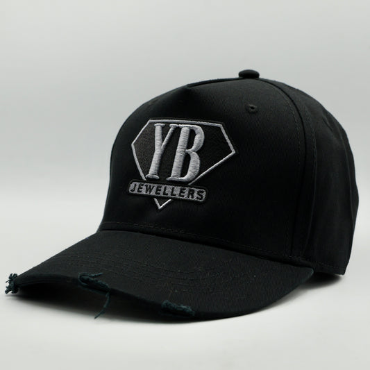 Black cap with YB Jewelers logo on a light gray background