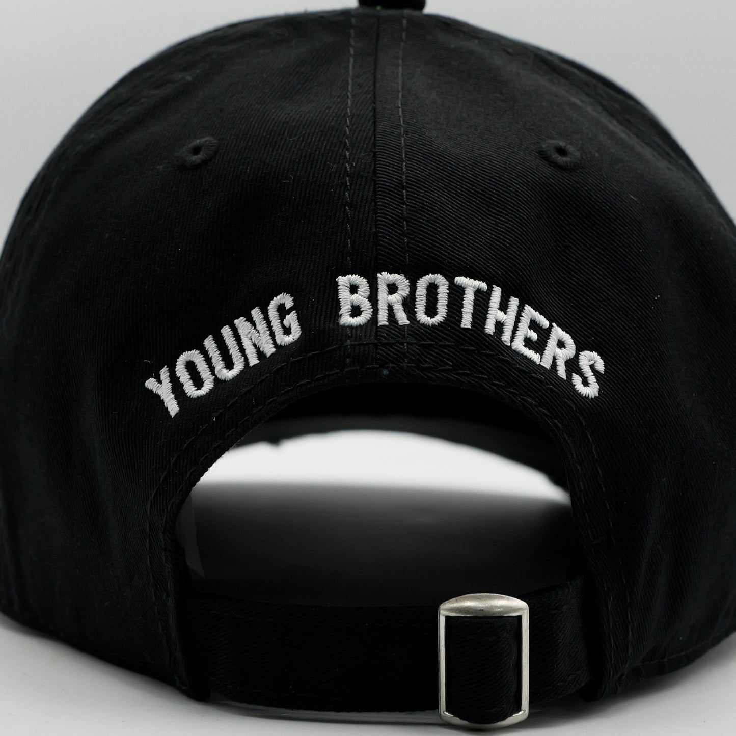 Black cap with 'YOUNG BROTHERS' embroidery on a gray background
