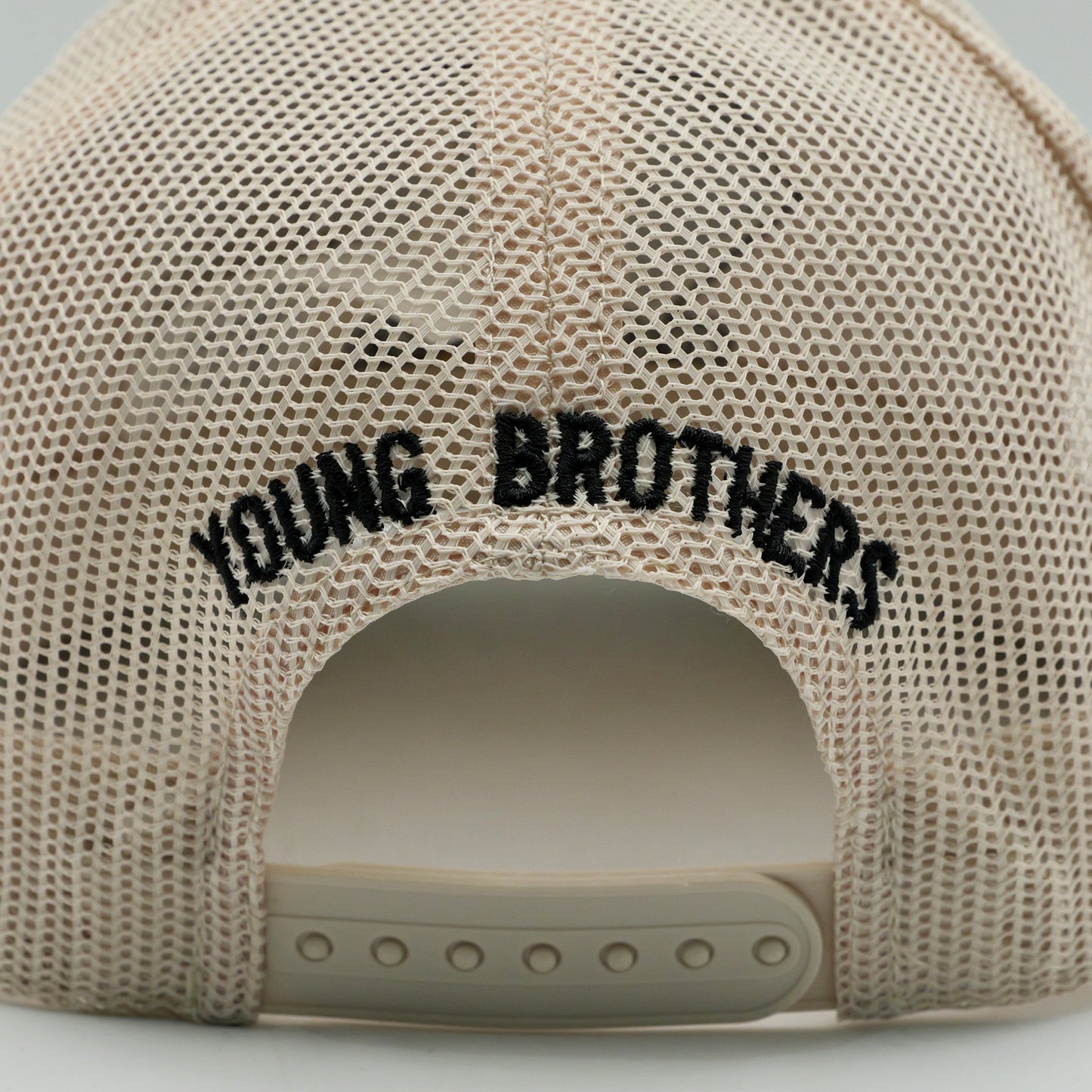 Beige mesh cap with 'YOUNG BROTHERS' text on a light gray background