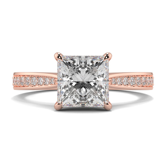 Rose gold ring with a large diamond and smaller diamonds on the band against a white background Yb jewellers engagement ring straight band princess cut diamond