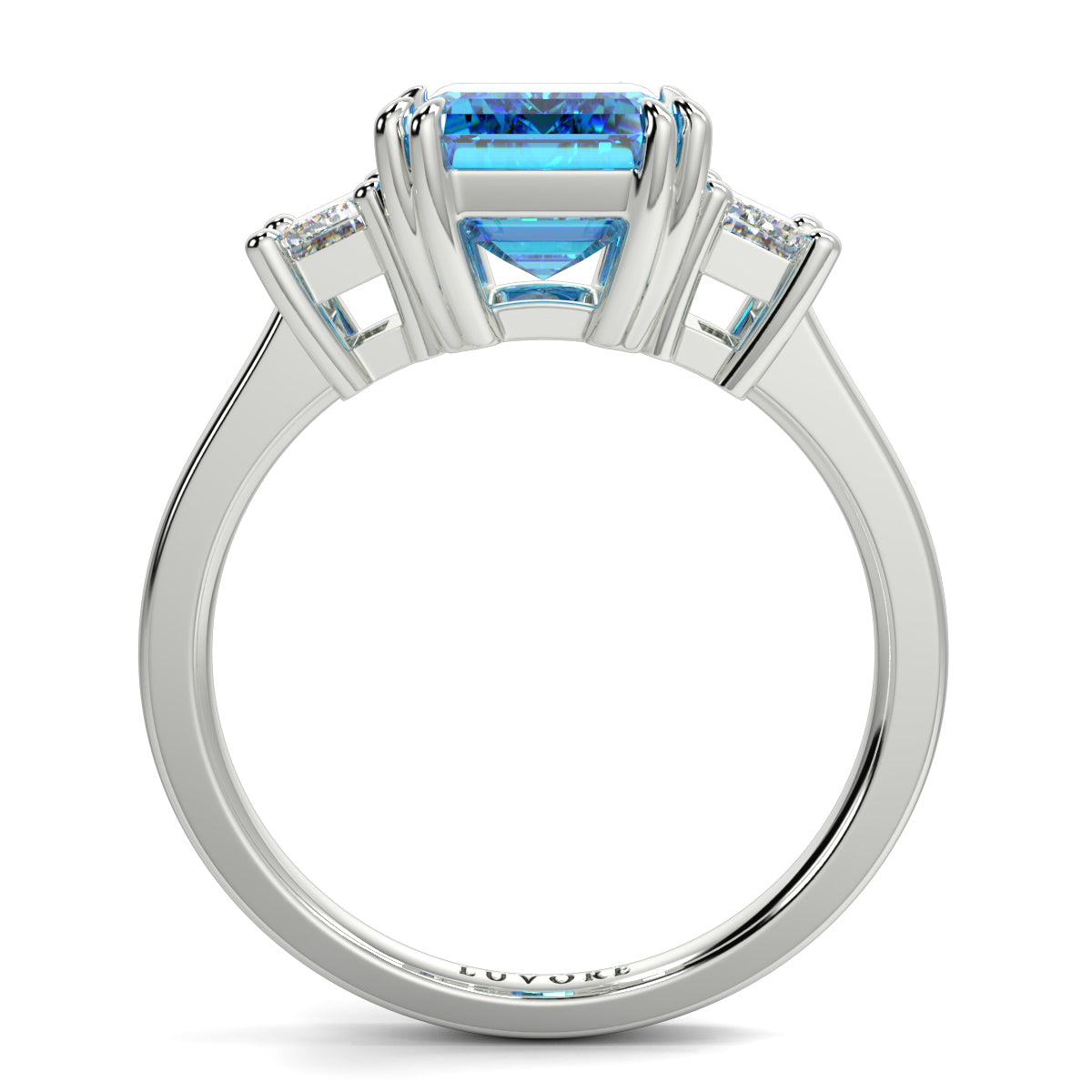 Silver ring with a blue gemstone and diamond accents on a white  yb jewellers trilogy emerald cut engagement ring lab grown diamonds coloured diamonds platinum ringbackground