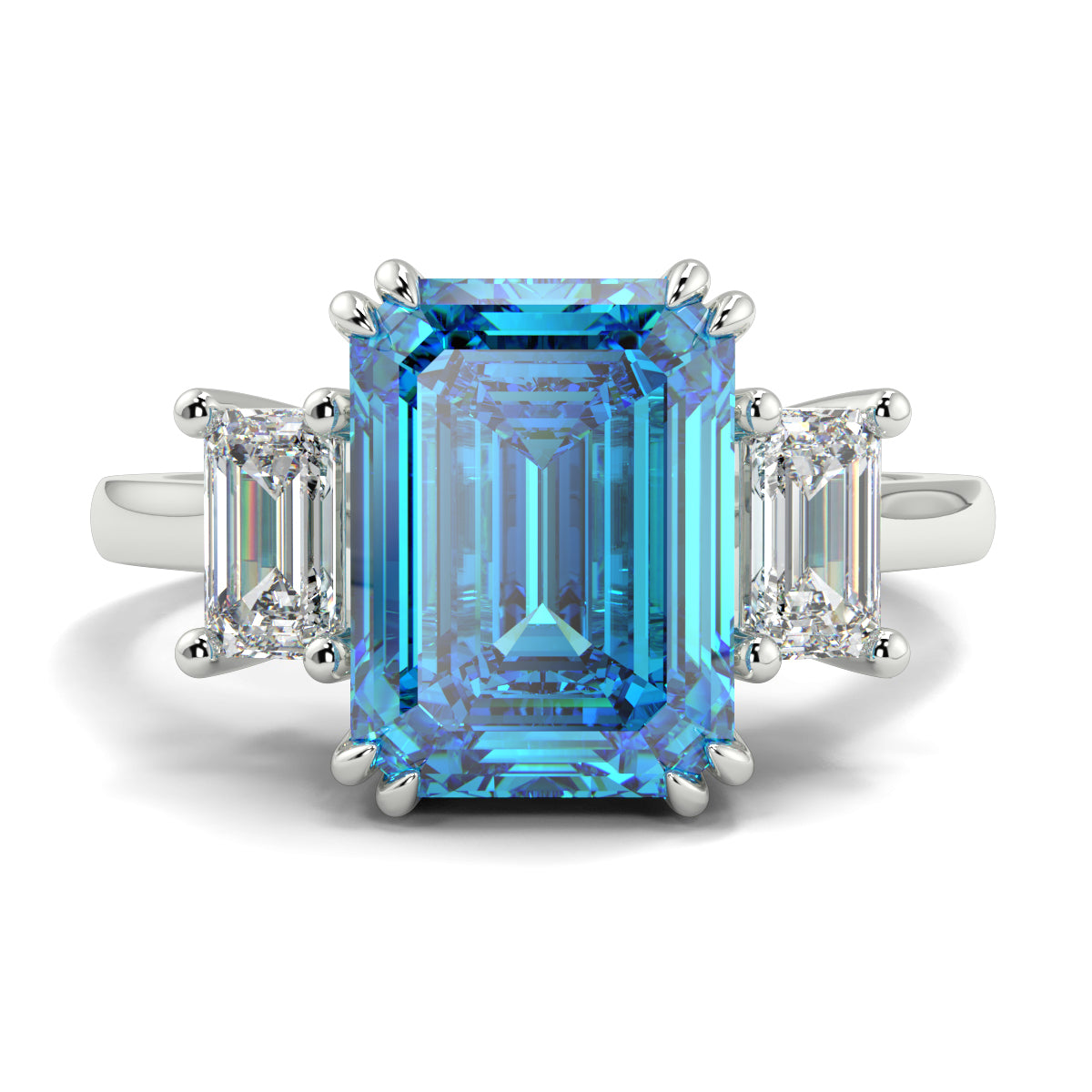 Ring with a blue gemstone and diamond accents on a white background yb jewellers trilogy emerald cut engagement ring lab grown diamonds coloured diamonds platinum ring