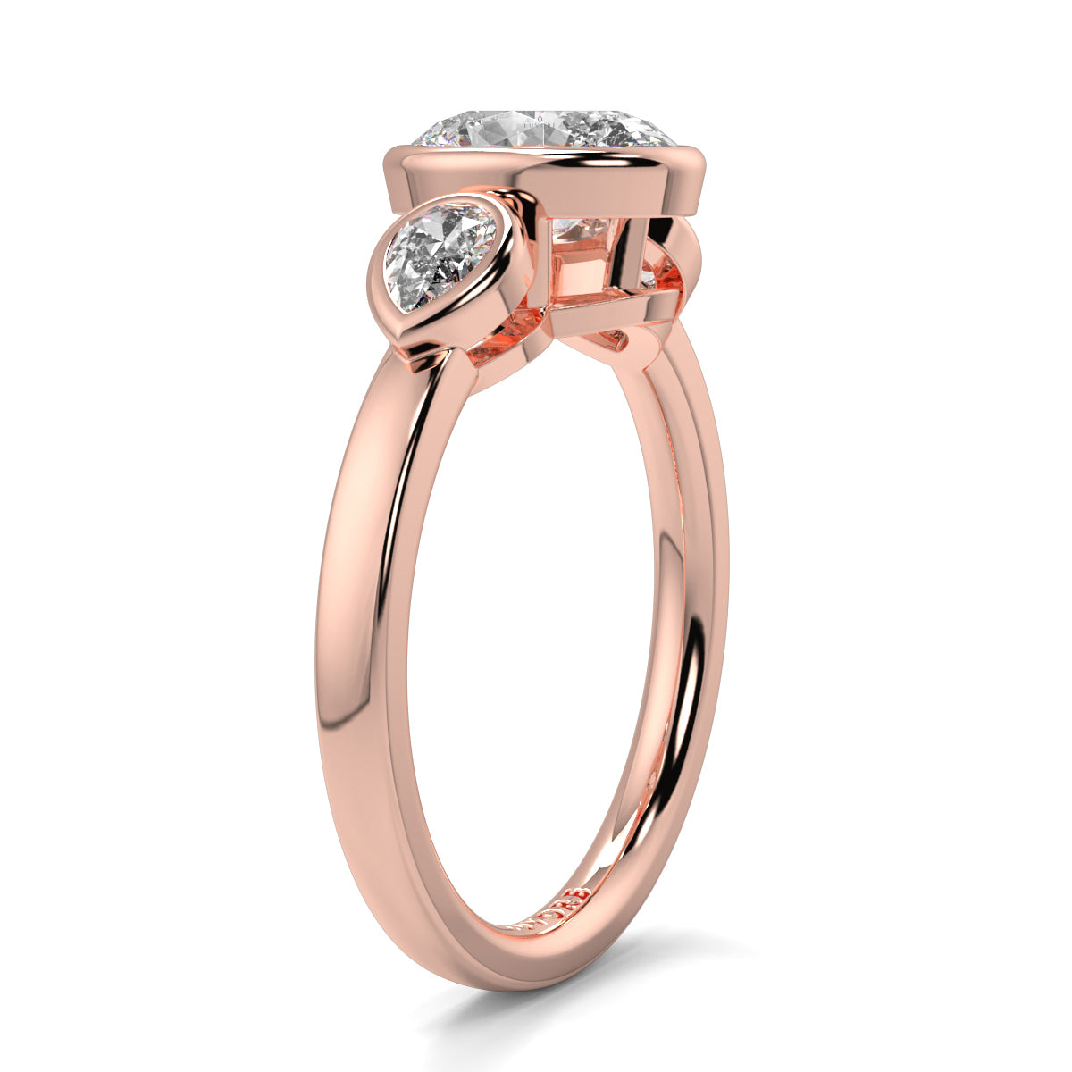 Rose gold ring with two diamond stones on a white background oval and pear diamond trilogy ring yb jewellers best selling design and engagement rings 