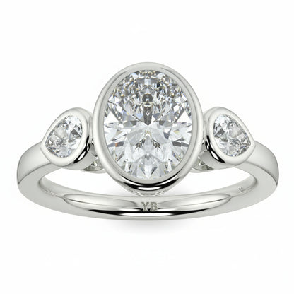 Silver ring with three diamonds on a white background oval and pear diamond trilogy ring yb jewellers best selling design and engagement rings 