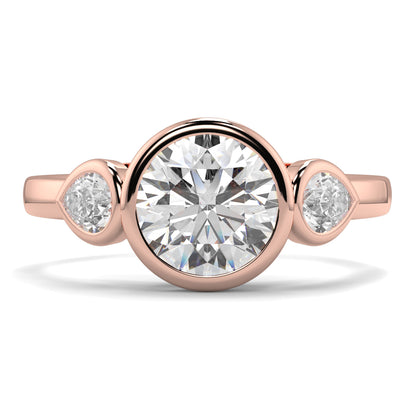 Rose gold ring with a central diamond and two smaller diamonds on a white background yb jewellers vintage athena ring design with 3 round diamonds best selling design and trending engagement ring 