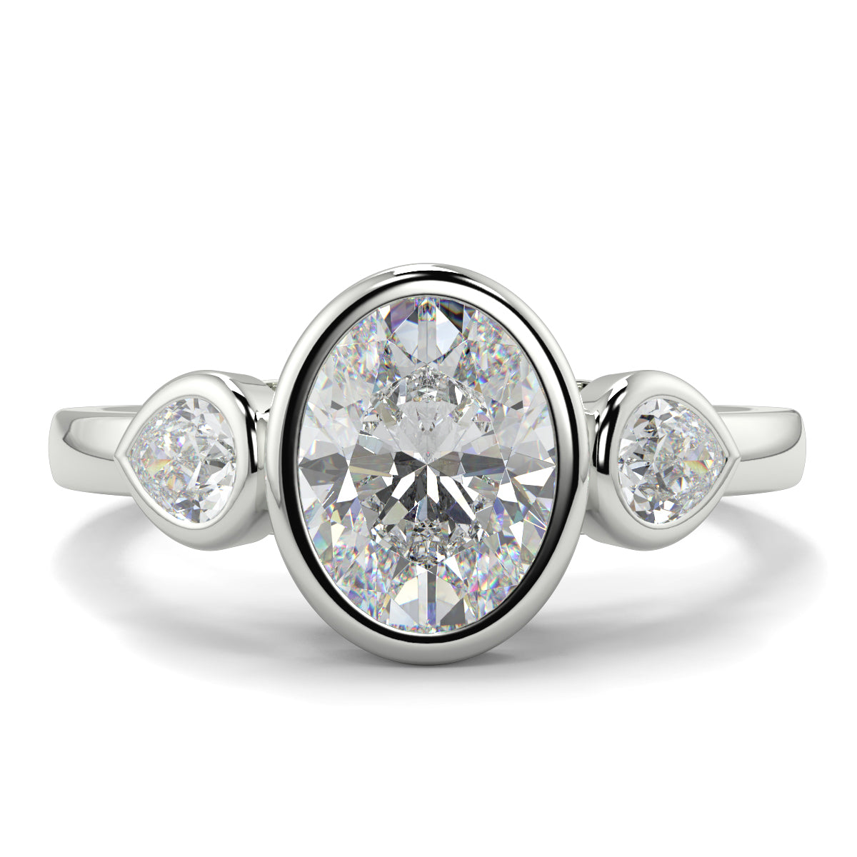 Diamond ring with three diamonds on a white background oval and pear diamond trilogy ring yb jewellers best selling design and engagement rings 