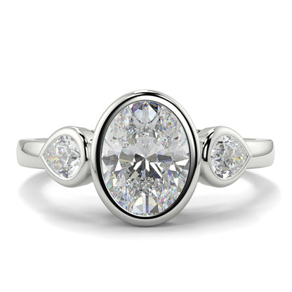 Diamond ring with three diamonds on a white background oval and pear diamond trilogy ring yb jewellers best selling design and engagement rings 