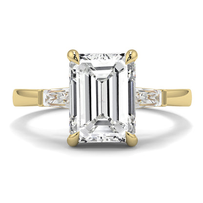 Gold ring with a large emerald-cut diamond on a white background yb_jewellers_3_stone_trilogy_engagement_ring_round_and_pear_shape_best_selling_design_trending_diamond_ring