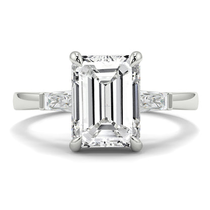 Diamond ring with emerald-cut center stone on a white background yb_jewellers_3_stone_trilogy_engagement_ring_round_and_pear_shape_best_selling_design_trending_diamond_ring