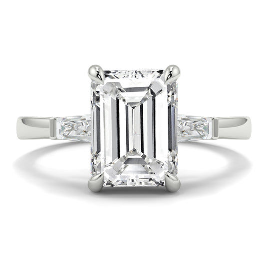 Diamond ring with emerald-cut center stone on a white background yb_jewellers_3_stone_trilogy_engagement_ring_round_and_pear_shape_best_selling_design_trending_diamond_ring