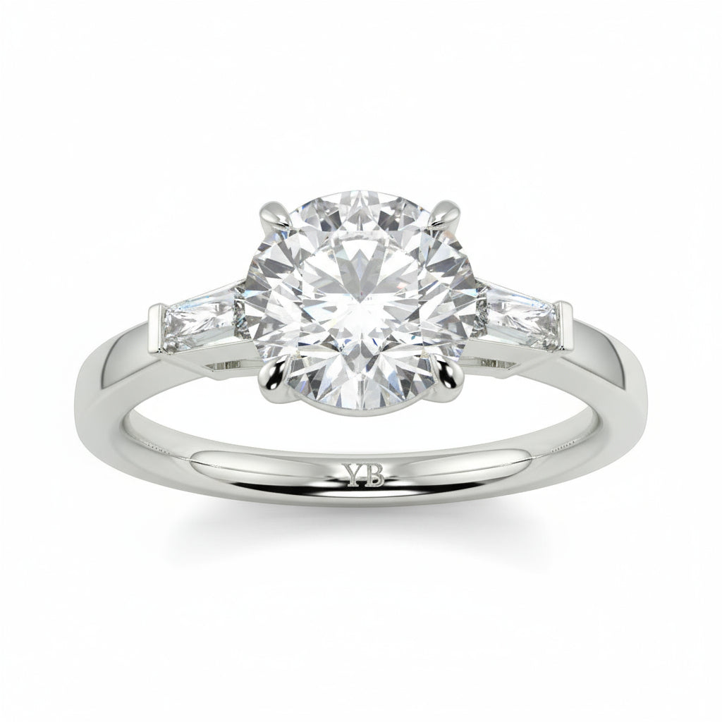 Diamond ring with a white background yb_jewellers_3_stone_trilogy_engagement_ring_round_and_pear_shape_best_selling_design_trending_diamond_ring