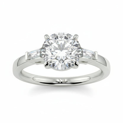 Diamond ring with a white background yb_jewellers_3_stone_trilogy_engagement_ring_round_and_pear_shape_best_selling_design_trending_diamond_ring