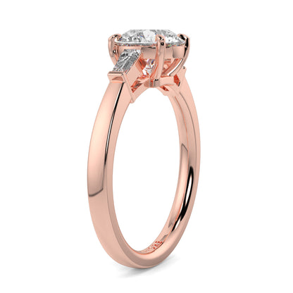 Rose gold ring with a diamond on a white background yb_jewellers_3_stone_trilogy_engagement_ring_round_and_pear_shape_best_selling_design_trending_diamond_ring