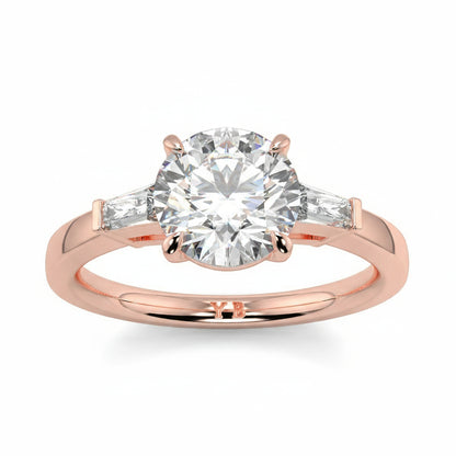 Rose gold ring with a large diamond and smaller diamonds on the sides, branded 'LUVONE'. yb_jewellers_3_stone_trilogy_engagement_ring_round_and_pear_shape_best_selling_design_trending_diamond_ring