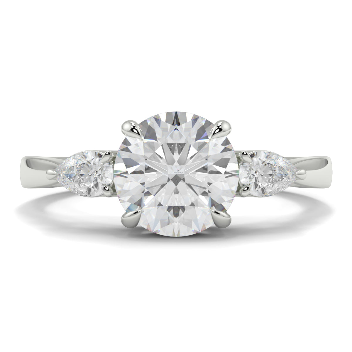 Diamond ring with a round center stone and pear-shaped side stones on a white background yb jewellers 3 stone trilogy engagement ring round and pear shape best selling design trending diamond ring