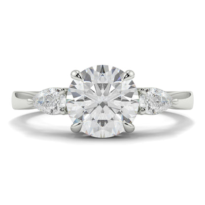 Diamond ring with a round center stone and pear-shaped side stones on a white background yb jewellers 3 stone trilogy engagement ring round and pear shape best selling design trending diamond ring