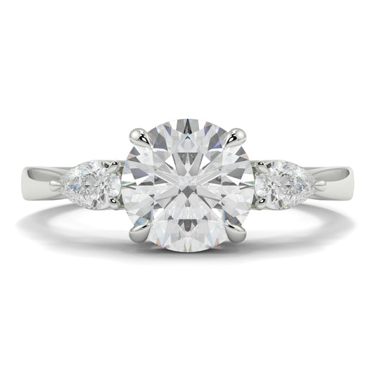 Diamond ring with a round center stone and pear-shaped side stones on a white background yb jewellers 3 stone trilogy engagement ring round and pear shape best selling design trending diamond ring