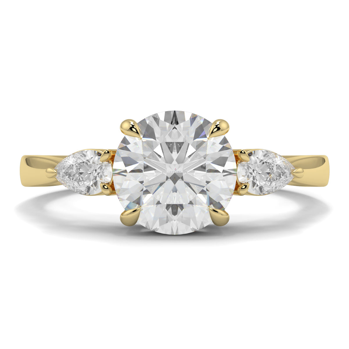Gold ring with a large diamond and two smaller diamonds on a white background yb jewellers 3 stone trilogy engagement ring round and pear shape best selling design trending diamond ring