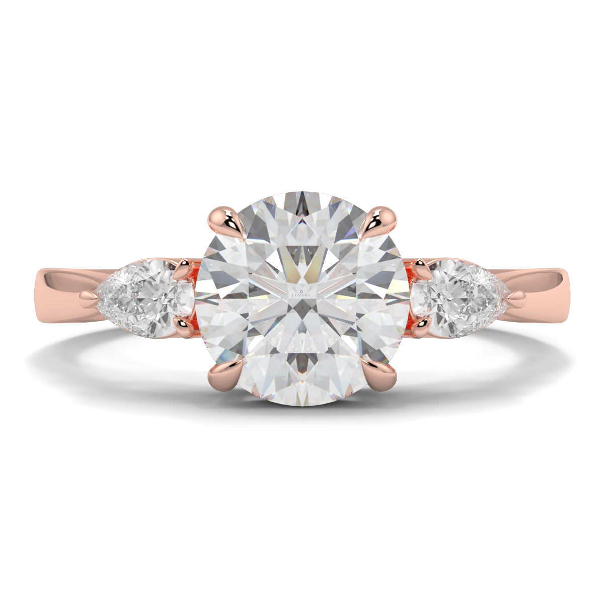 Rose gold ring with a large diamond and two smaller diamonds on a white background yb jewellers 3 stone trilogy engagement ring round and pear shape best selling design trending diamond ring