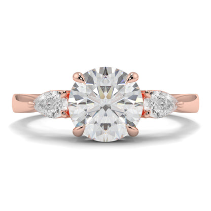 Rose gold ring with a large diamond and two smaller diamonds on a white background yb jewellers 3 stone trilogy engagement ring round and pear shape best selling design trending diamond ring