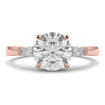 Rose gold ring with a large diamond on a white background yb_jewellers_3_stone_trilogy_engagement_ring_round_and_pear_shape_best_selling_design_trending_diamond_ring