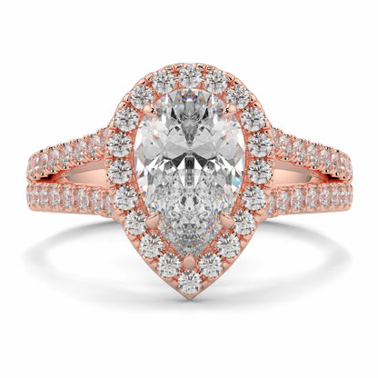 Rose gold diamond ring with a pear-shaped center stone on a white background yb jewellers twist halo pear shape engagement diamond ring best selling design ring and trending design 2026