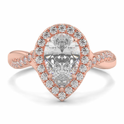 Rose gold ring with a pear-shaped diamond and diamond halo on a white background yb jewellers twist halo pear shape engagement diamond ring best selling design ring and trending design 2026