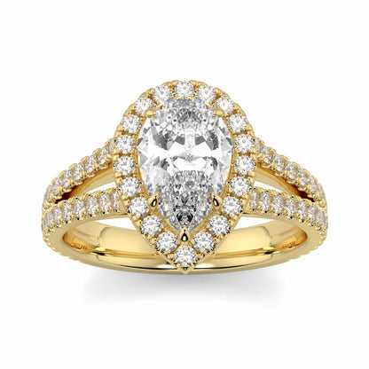 Gold ring with a pear-shaped diamond and smaller diamonds on a white background yb jewellers twist halo pear shape engagement diamond ring best selling design ring and trending design 2026