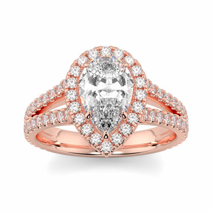 Rose gold ring with a pear-shaped diamond and smaller diamonds on a white background yb jewellers twist halo pear shape engagement diamond ring best selling design ring and trending design 2026