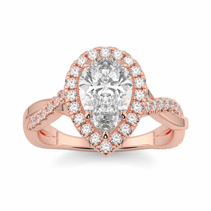 Rose gold ring with a pear-shaped diamond and smaller diamonds on a white background yb jewellers twist halo pear shape engagement diamond ring best selling design ring and trending design 2026
