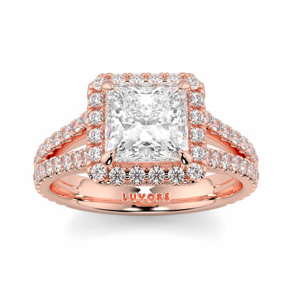 Rose gold ring with a large diamond and smaller diamonds on a white background yb jewellers twist halo princess shape engagement diamond ring best selling design ring and trending design 2026