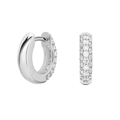 Silver hoop earrings with embedded stones on a green background pair of huggiee earrings in 18k white gold platinum with micro diamond setting by yb jewellers 