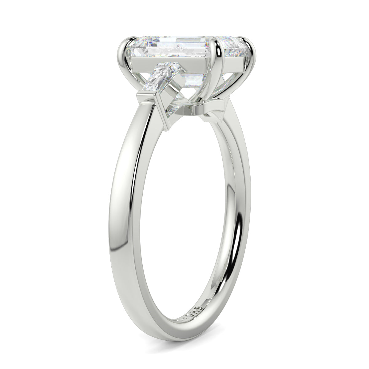 Diamond ring with a rectangular cut gemstone on a white background yb_jewellers_3_stone_trilogy_engagement_ring_round_and_pear_shape_best_selling_design_trending_diamond_ring