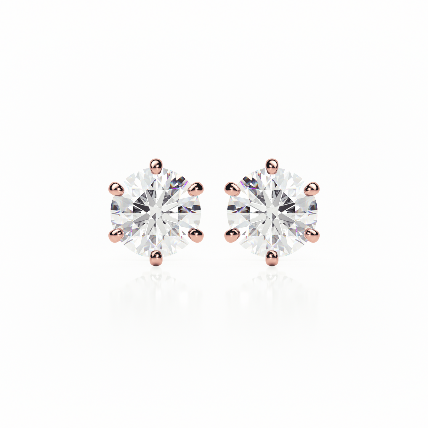 Pair of diamond stud earrings with rose gold prongs on a white background yb jewellers earrings best sellers