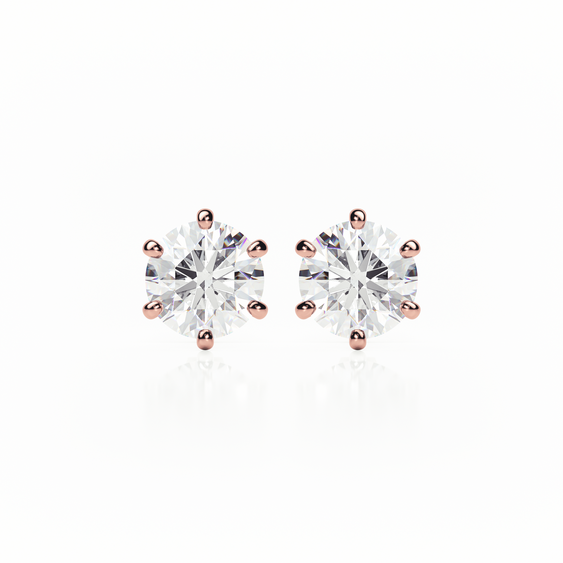 Pair of diamond stud earrings with rose gold prongs on a white background yb jewellers earrings best sellers