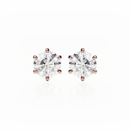 Pair of diamond stud earrings with rose gold prongs on a white background yb jewellers earrings best sellers