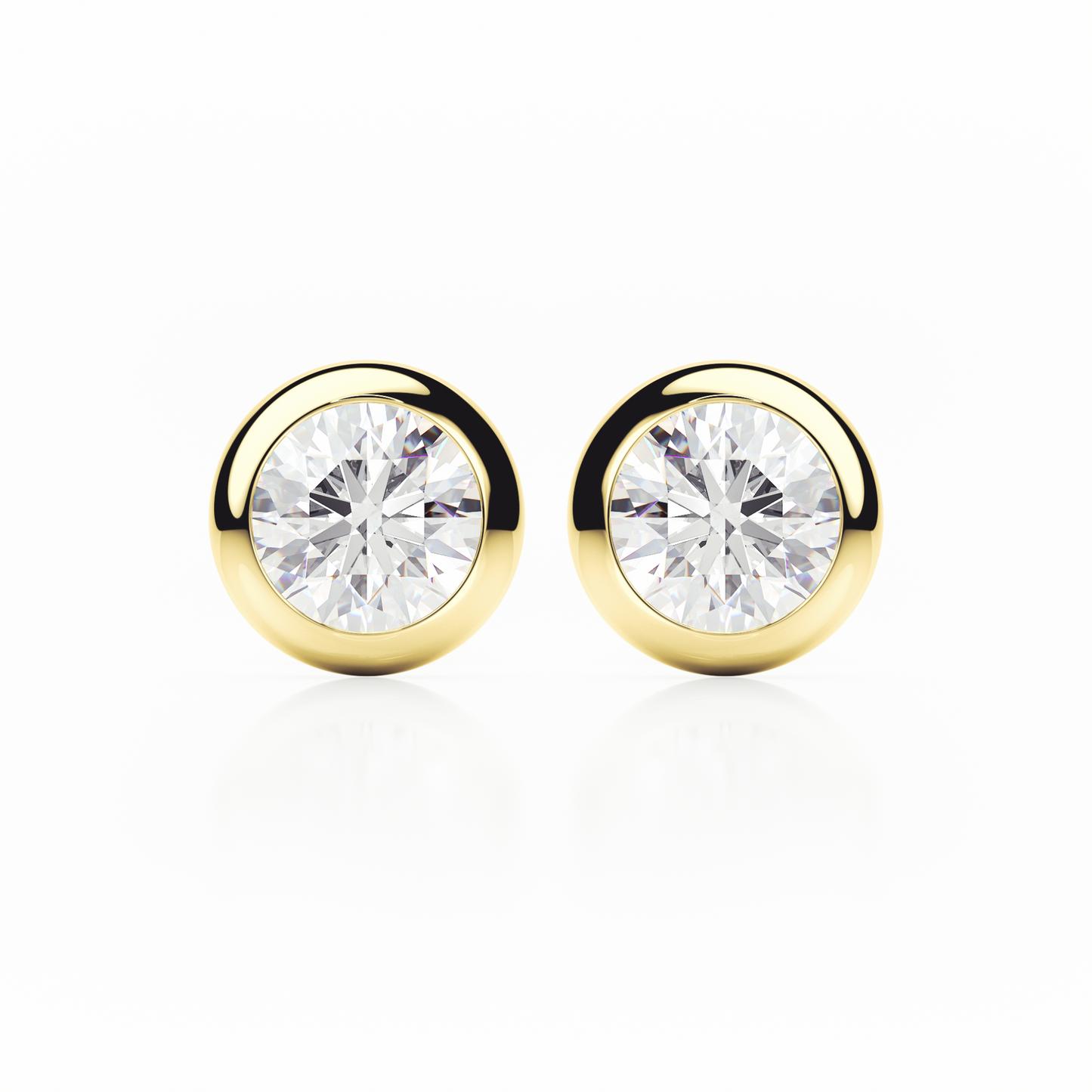 Gold earrings with clear gemstones on a white background