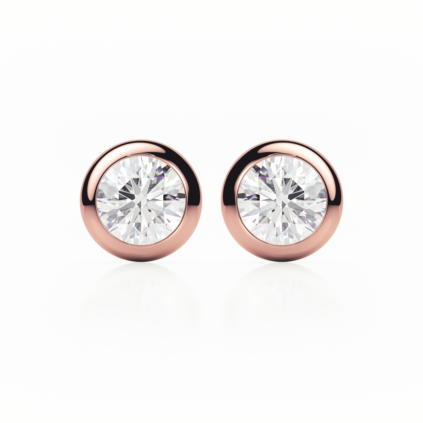 Rose gold earrings with clear gemstones on a white background