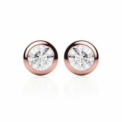 Rose gold earrings with clear gemstones on a white background