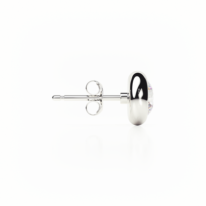 Silver earring with a clear gemstone on a white background