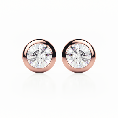 Rose gold earrings with clear gemstones on a white background
