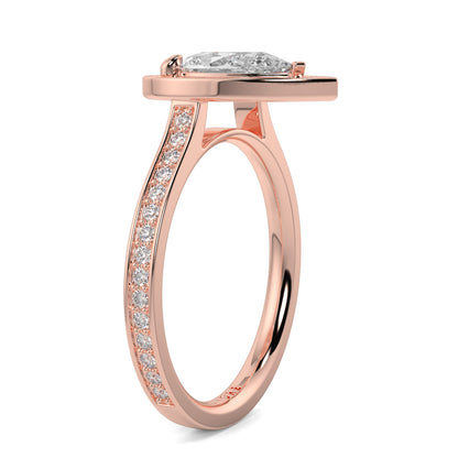 Rose gold ring with a diamond on a white background Pear shaped diamond engagement ring Yb jewellers trending ring designs