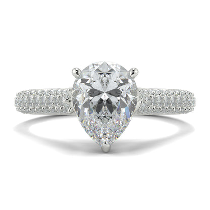 Diamond ring with a pear-shaped center stone on a white background Yb jewellers engagement ring straight band