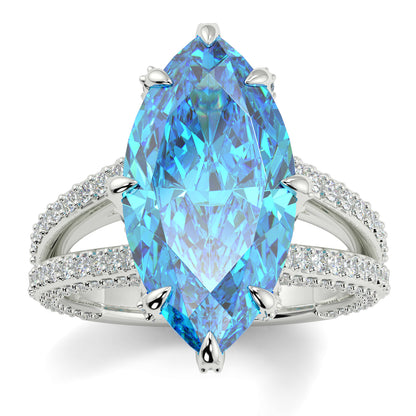 Ring with a large blue gemstone and smaller diamonds on a white background yb jewellers marquise split diamond engagement ring with diamond set band and diamond encrusted collet vintage marquise lab grown blue diamond ring