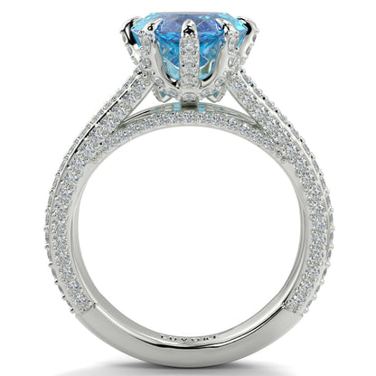 Elegant ring with a blue gemstone and diamond-studded band on a white background yb jewellers marquise split diamond engagement ring with diamond set band and diamond encrusted collet vintage marquise lab grown blue diamond ring