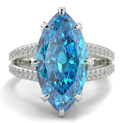 Ring with a blue gemstone and diamond-studded band on a white background yb jewellers marquise split diamond engagement ring with diamond set band and diamond encrusted collet vintage marquise lab grown blue diamond ring