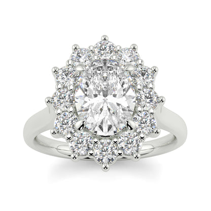 Diamond ring with a halo of smaller diamonds on a white background Yb jewellers engagement ring with a cluster halo and oval diamond trending design 