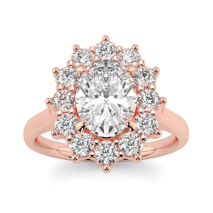Rose gold ring with a large central diamond and smaller diamonds around on a white background Yb jewellers engagement ring with a cluster halo and oval diamond trending design 