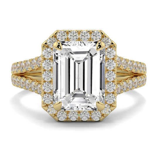 Gold ring with emerald-cut diamond and smaller diamonds on a white background Yb jewellers emerald split halo diamond engagement ring 